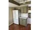 Kitchen featuring stainless steel refrigerator and olive green cabinets at 8641 Surtidor Dr, Las Vegas, NV 89117