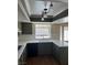 Kitchen features olive green cabinets, white countertops, stainless steel sink, and updated lighting at 8641 Surtidor Dr, Las Vegas, NV 89117