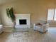 Living room with white fireplace and hearth, tan carpet and neutral walls at 8641 Surtidor Dr, Las Vegas, NV 89117