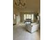 Spacious living room with neutral carpet, fireplace, chandelier, and bay window at 8641 Surtidor Dr, Las Vegas, NV 89117
