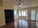 Living room with wood flooring, custom cabinets, bay windows with shutter shades, and kitchen view at 8641 Surtidor Dr, Las Vegas, NV 89117