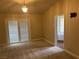 Bedroom with sliding door and bathroom entry, accented with neutral carpeting and wall color at 8641 Surtidor Dr, Las Vegas, NV 89117