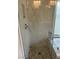 Bathroom shower with clear glass enclosure featuring neutral mosaic tile flooring at 8641 Surtidor Dr, Las Vegas, NV 89117