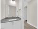 Modern powder room featuring white cabinets, gray countertops, and a sleek mirror at 9176 Bluebell Knoll Ct, Las Vegas, NV 89178