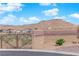 A gate provides access to this community set against a backdrop of desert landscape at 9176 Bluebell Knoll Ct, Las Vegas, NV 89178