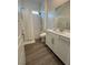 Bathroom featuring a shower-tub combo with white subway tile and a large vanity at 928 Woodburn Ln, Las Vegas, NV 89138