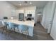 Modern kitchen featuring stainless steel appliances, a quartz countertop, and an island with seating at 928 Woodburn Ln, Las Vegas, NV 89138