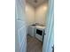 Compact laundry room with modern washer and dryer units for convenient chores at 928 Woodburn Ln, Las Vegas, NV 89138