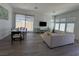 Bright living room with hardwood floors, plenty of natural light, and modern furniture at 928 Woodburn Ln, Las Vegas, NV 89138