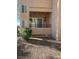 A private balcony with a sun decoration, small plants and curtains creates a cozy outdoor space at 9325 W Desert Inn Rd # 174, Las Vegas, NV 89117