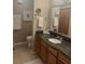 Bathroom featuring granite countertop vanity with a mirror, toilet, and decorative floor tiles at 9325 W Desert Inn Rd # 174, Las Vegas, NV 89117