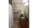 Bathroom featuring a vanity with a granite countertop, tub/shower combo, and decorative floor tiles at 9325 W Desert Inn Rd # 174, Las Vegas, NV 89117