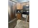 Well-lit kitchen featuring stainless steel appliances and a cozy rug on the tile floor at 9325 W Desert Inn Rd # 174, Las Vegas, NV 89117