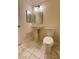 Bathroom featuring a pedestal sink with two mirrors and a white toilet on marble tile floors at , Las Vegas, NV 89103