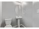 Small powder bathroom features a toilet and single pedestal sink at 10160 W Meranto Ave, Las Vegas, NV 89178