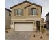 Two-story home with a neutral color, two-car garage, symmetrical windows, and decorative shutters at 10160 W Meranto Ave, Las Vegas, NV 89178