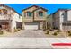 Inviting two-story home with a brick driveway and manicured landscaping at 10160 W Meranto Ave, Las Vegas, NV 89178
