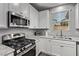 Close-up of updated kitchen with stainless steel appliances and granite countertops at 10160 W Meranto Ave, Las Vegas, NV 89178