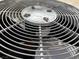 Close-up of an air conditioner fan showcasing its protective grill design and internal components at 11031 Mission Lakes Ave, Las Vegas, NV 89134