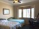 Comfortable bedroom features two twin beds, a ceiling fan, and a sunlit bay window at 11031 Mission Lakes Ave, Las Vegas, NV 89134