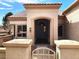 Inviting home entrance with a tiled roof, desert landscaping, and stone pillars at 11031 Mission Lakes Ave, Las Vegas, NV 89134