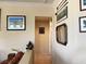 Hallway with neutral paint, tile floors, and decorative wall art leading to other rooms at 11031 Mission Lakes Ave, Las Vegas, NV 89134