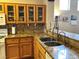 Gourmet kitchen boasts granite countertops, stainless steel appliances, and a stylish backsplash at 11031 Mission Lakes Ave, Las Vegas, NV 89134