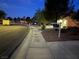 A street view of a home for sale, desert landscaping, and sidewalks at 11031 Mission Lakes Ave, Las Vegas, NV 89134