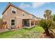Home featuring a private backyard with a covered patio, lush lawn and mature landscaping at 11620 Longhirst Hall Ln, Las Vegas, NV 89138