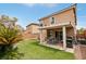 Backyard featuring a covered patio, lawn, and landscaping at 11620 Longhirst Hall Ln, Las Vegas, NV 89138