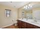 Bathroom featuring a dual sink vanity with a large mirror and modern fixtures at 11620 Longhirst Hall Ln, Las Vegas, NV 89138
