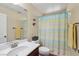 Bathroom with blue shower curtain and single sink vanity at 11620 Longhirst Hall Ln, Las Vegas, NV 89138