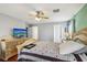 Bedroom featuring a large bed, wood floors, and a flat screen TV at 11620 Longhirst Hall Ln, Las Vegas, NV 89138