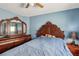 A primary bedroom with a large bed, wood accents, and ambient lighting at 11620 Longhirst Hall Ln, Las Vegas, NV 89138