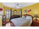 Bedroom featuring a ceiling fan and a large bed with a patterned comforter at 11620 Longhirst Hall Ln, Las Vegas, NV 89138