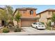 Two-story home showing front yard with desert landscaping and large driveway, attached two-car garage at 11620 Longhirst Hall Ln, Las Vegas, NV 89138
