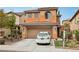 Two-story home with a terracotta-colored roof, a two-car garage, and desert landscaping at 11620 Longhirst Hall Ln, Las Vegas, NV 89138
