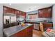 Spacious kitchen with stainless steel appliances, center island, and breakfast nook with backyard view at 11620 Longhirst Hall Ln, Las Vegas, NV 89138