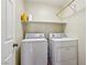 Laundry room with a washer, dryer, and storage shelf at 11620 Longhirst Hall Ln, Las Vegas, NV 89138