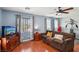 Cozy living room with hardwood floors, a comfortable couch, and an entertainment center at 11620 Longhirst Hall Ln, Las Vegas, NV 89138