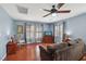 Inviting living room featuring wood floors, a comfortable couch, and a ceiling fan at 11620 Longhirst Hall Ln, Las Vegas, NV 89138