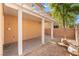 Covered patio and backyard, with concrete, adjacent to a stucco house wall, with natural shade from a tree at 11673 Pride Hill St, Las Vegas, NV 89183