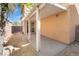 Covered patio with stone, leading to the backyard, featuring a stucco wall and access to the home at 11673 Pride Hill St, Las Vegas, NV 89183
