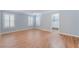 Primary bedroom featuring wood floors, plantation shutters, and a walk in closet at 11673 Pride Hill St, Las Vegas, NV 89183