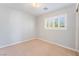 Cozy bedroom with a large window with shutters and neutral carpet at 11673 Pride Hill St, Las Vegas, NV 89183