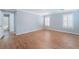 Spacious bedroom featuring wood floors, plantation shutters, and an ensuite bathroom at 11673 Pride Hill St, Las Vegas, NV 89183