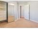 Bedroom with mirrored closet doors, neutral carpet, and a glimpse into an adjacent room at 11673 Pride Hill St, Las Vegas, NV 89183