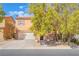 Attractive home with a two-car garage, desert landscaping, and beautiful mature shade trees at 11673 Pride Hill St, Las Vegas, NV 89183