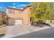 Charming two-story home featuring a stucco exterior, attached garage, and desert landscaping at 11673 Pride Hill St, Las Vegas, NV 89183