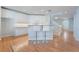 Open kitchen with white cabinets, bar seating, and hardwood floors connecting to the living area at 11673 Pride Hill St, Las Vegas, NV 89183